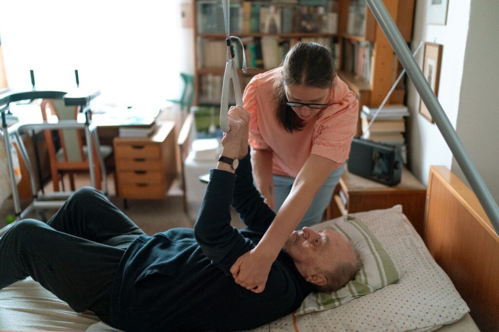 A support worker sitting and talking warmly with a person at home