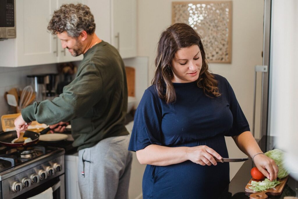 Two people preparing a meal together in a kitchen