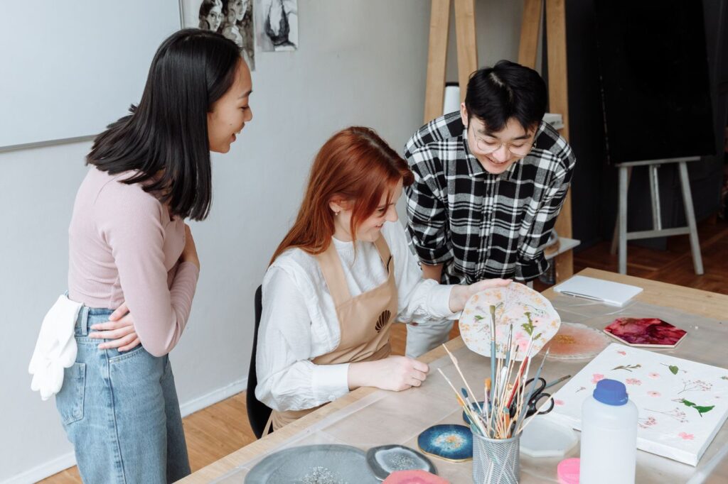 Adults taking part in a painting activity in an art studio